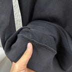 Black sweatshirt cuff and sleeve seam detail, ribbed knit