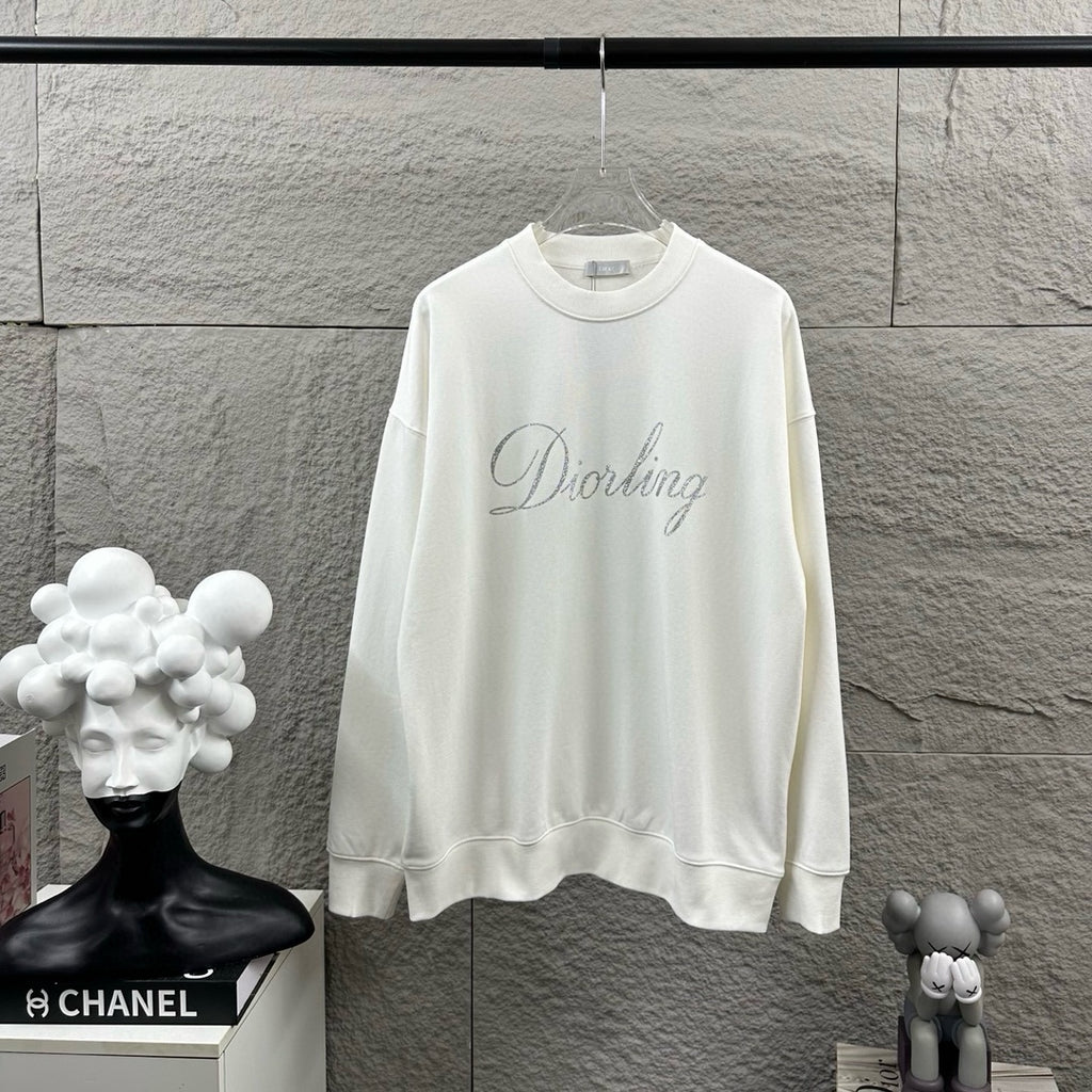 White long-sleeve sweatshirt with crew neck and glitter script logo on chest.