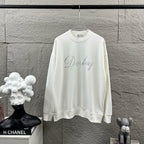 White long-sleeve sweatshirt with crew neck and glitter script logo on chest.