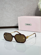 MiuMiu tortoise-brown sunglasses with gold-tone arms and dark tinted lenses