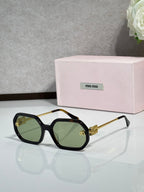 MiuMiu dark green sunglasses with gold-tone arms and gradient tinted lenses