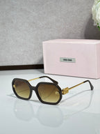 MiuMiu brown sunglasses with gold-tone arms and amber tinted lenses