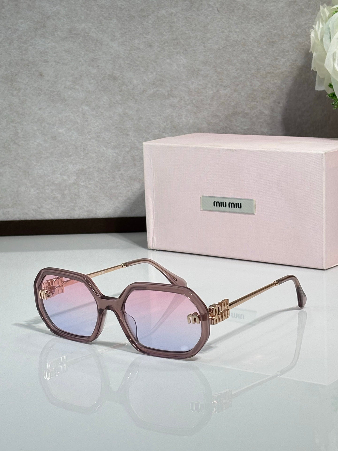MiuMiu rose-brown sunglasses with gold-tone arms and pink tinted lenses