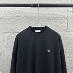 Black crewneck sweatshirt with small white logo on chest