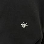 Small white logo on black crewneck sweatshirt