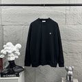 Long-sleeve crewneck sweatshirt in black with small white logo on chest