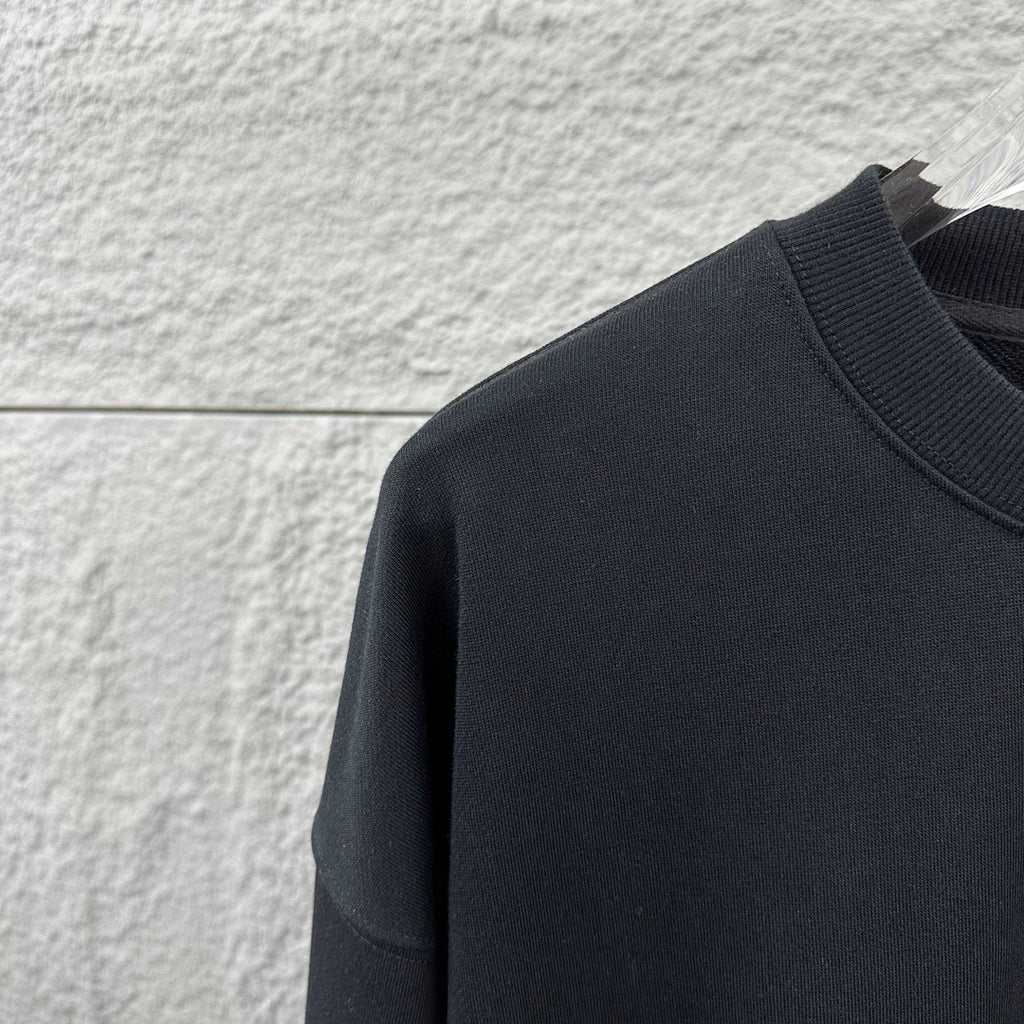 Dark sweatshirt knit fabric panel with crew neckline area