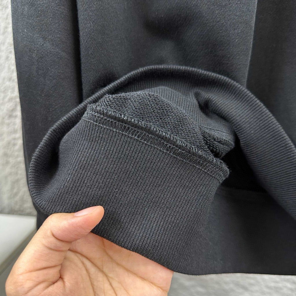 Black sweatshirt knit hem and stitched seam detail