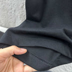 Black T-shirt fabric with stitched hem and sleeve seam detail