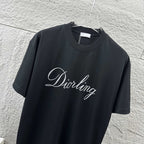 Close-up: black short-sleeve crewneck T-shirt with “Diortling” script logo