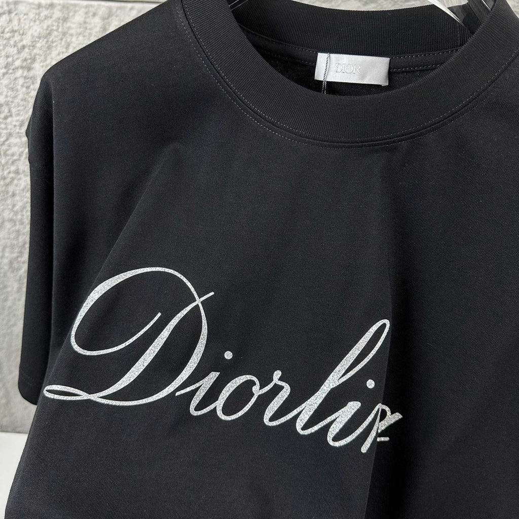 Close-up of black T-shirt neckline and “Diortling” script logo