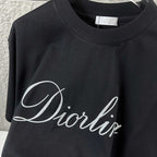 Close-up of black T-shirt neckline and “Diortling” script logo