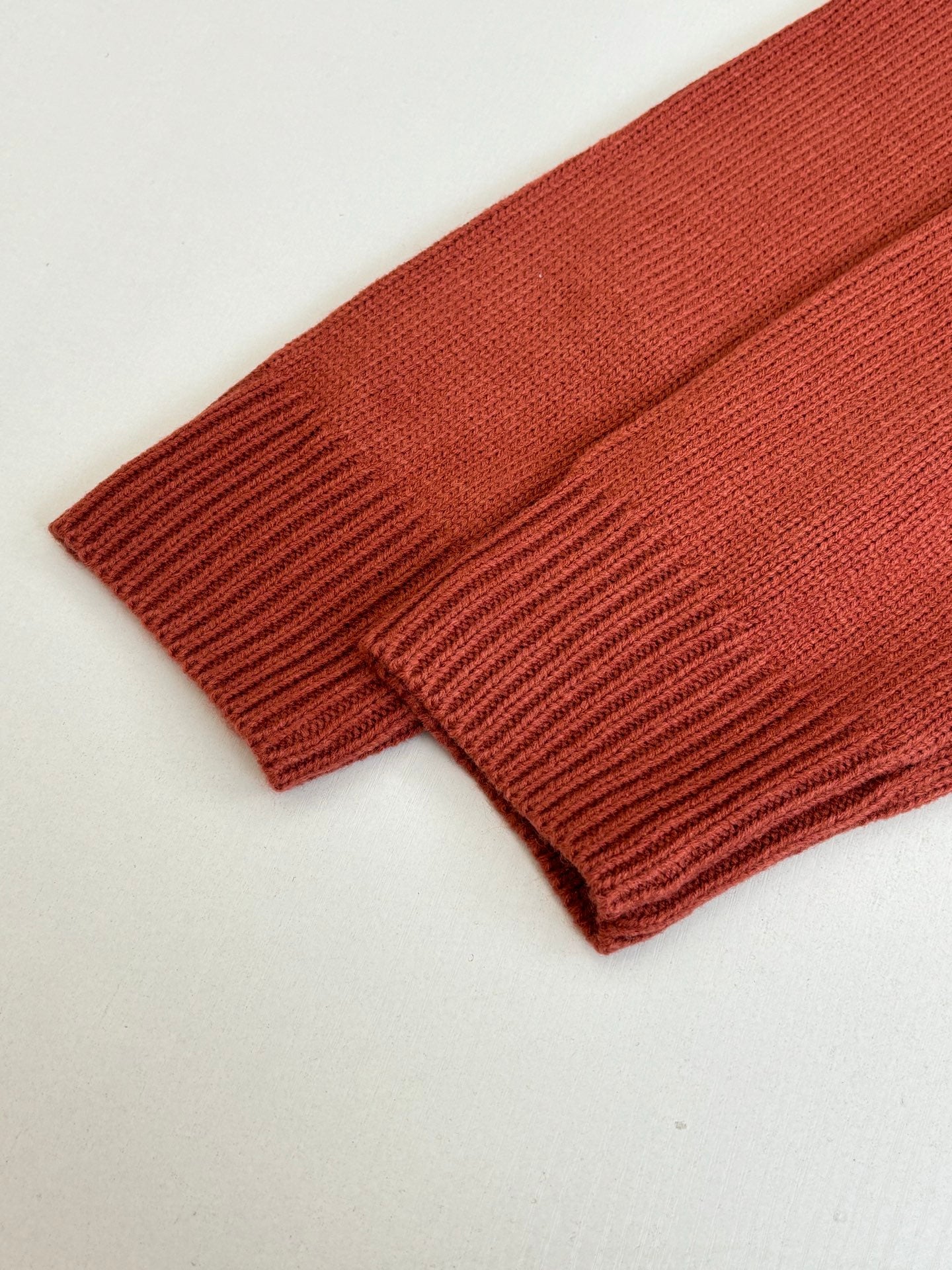 Dior knit sweater hem and sleeve cuff, rust red ribbed knit detail