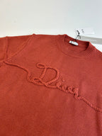 Dior knit sweater chest, rust red, embroidered script logo along the front