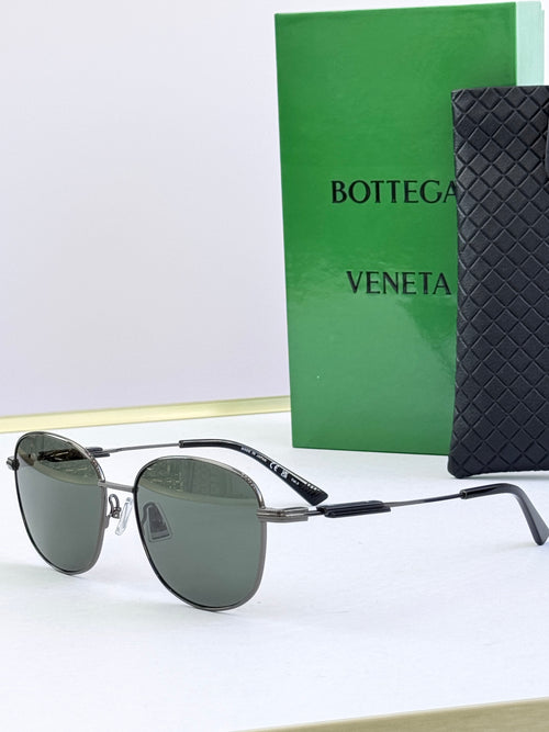 Round sunglasses with dark green lenses and silver metal frames