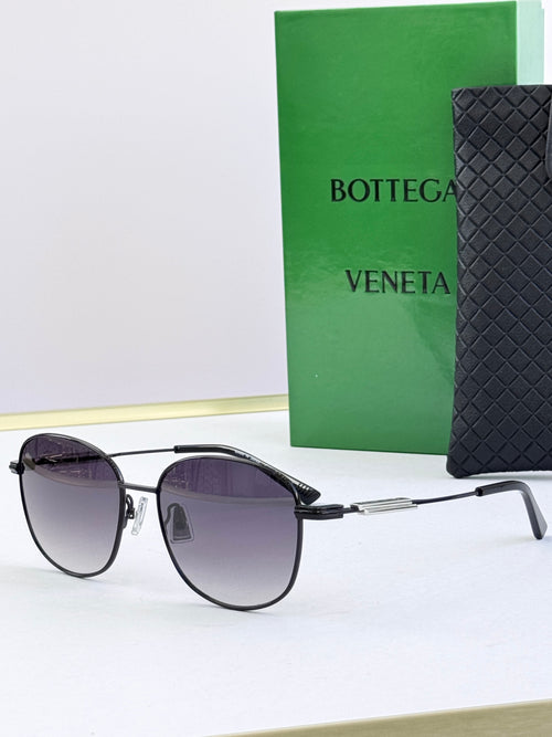 Round sunglasses with dark purple lenses and black metal frames