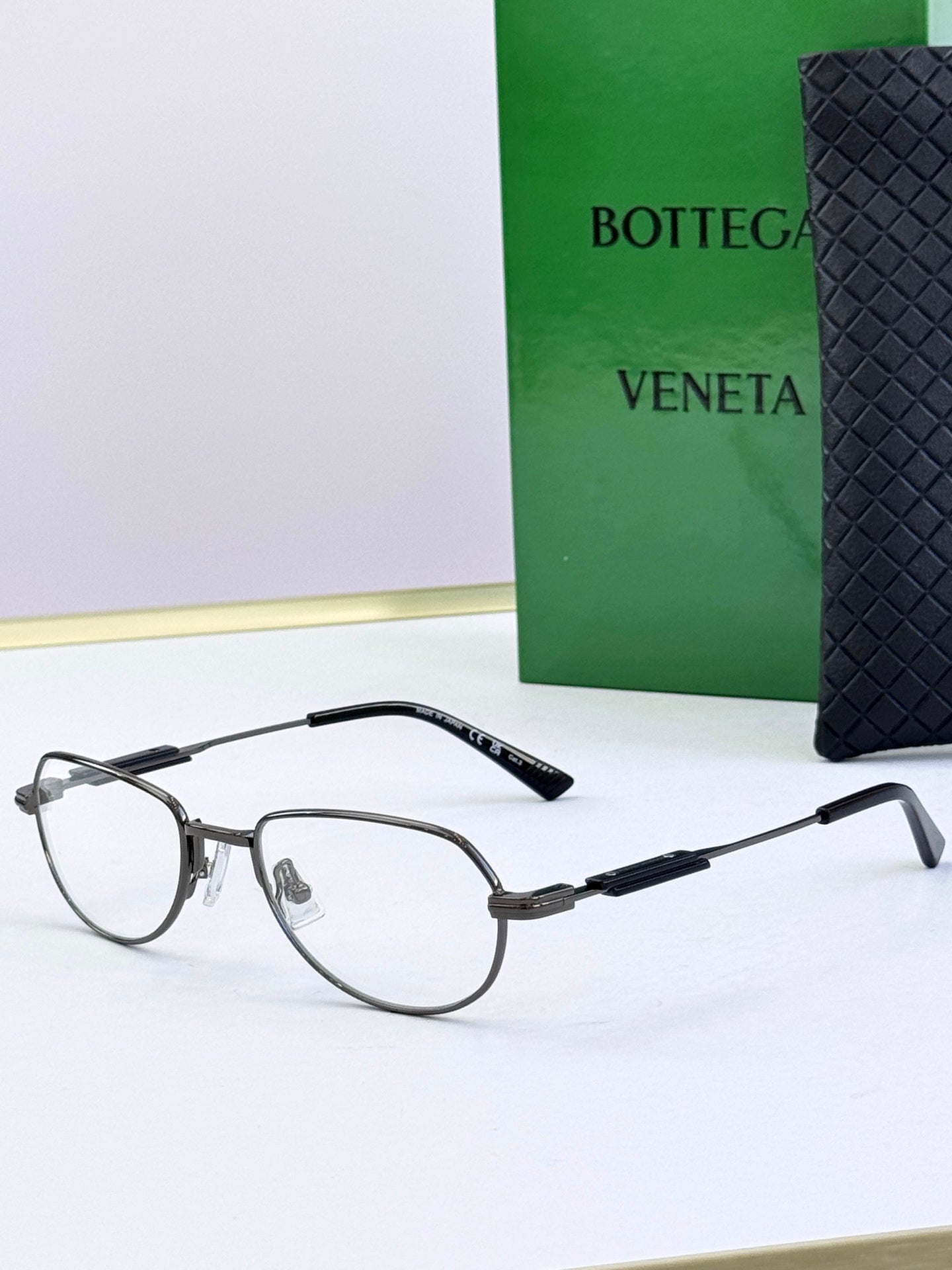 Bottega Veneta glasses with clear lenses and gray frames