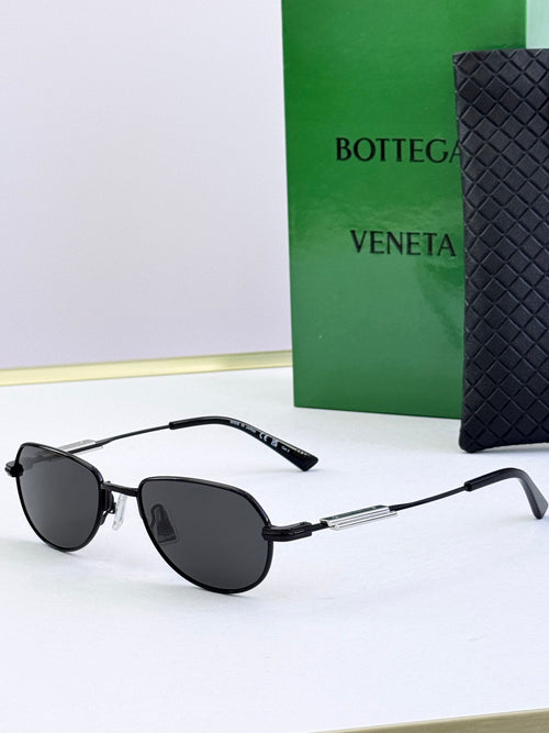 Bottega Veneta glasses with black frames and dark round lenses