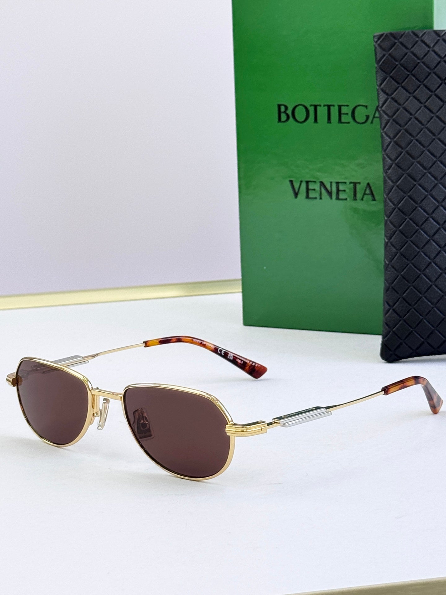 Bottega Veneta glasses with gold frames, tortoise arms, brown tinted lenses