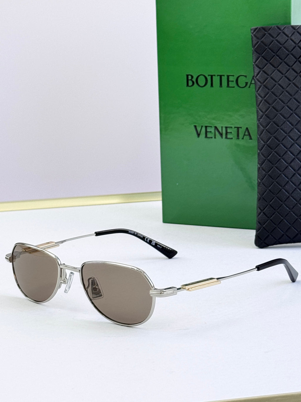 Bottega Veneta glasses with silver frames and brown tinted lenses