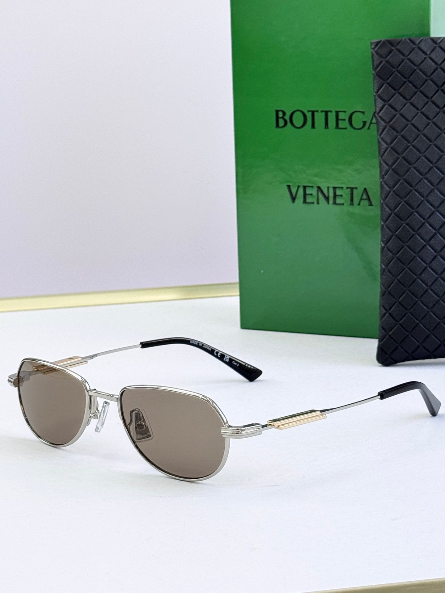 Bottega Veneta glasses with silver frames and brown tinted lenses