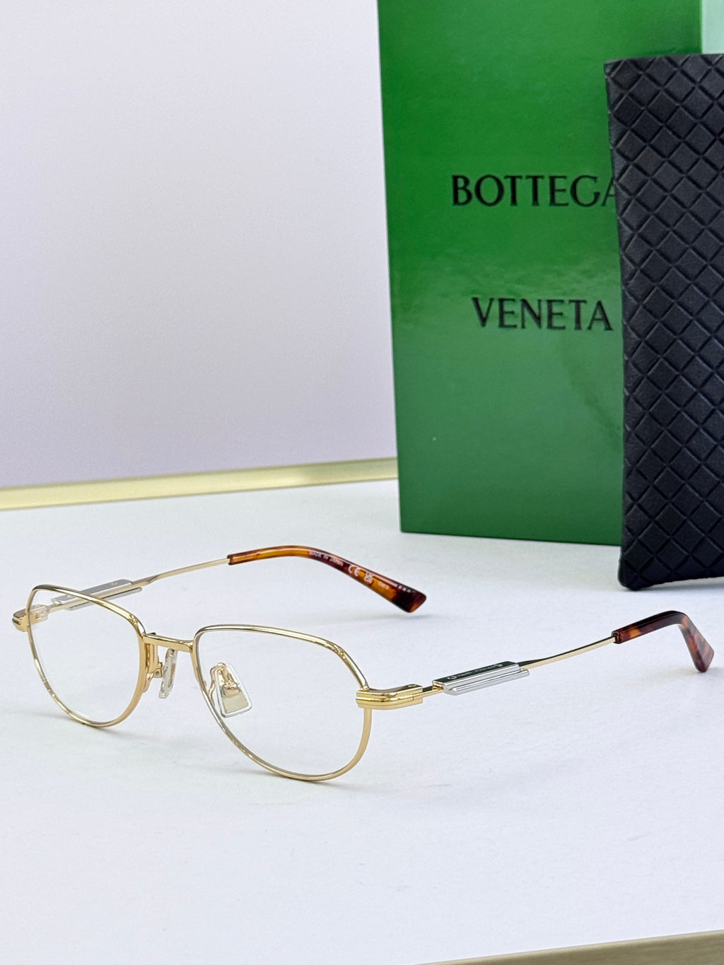 Bottega Veneta glasses with gold frames, tortoise arms, brown tinted lenses