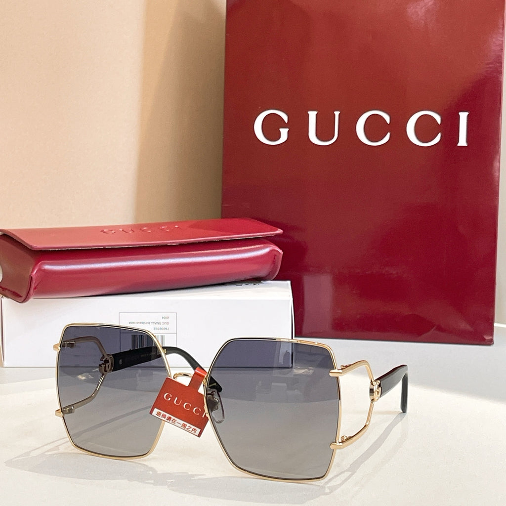 Gucci sunglasses with square gradient lenses and gold-tone frames, blue-gray tones