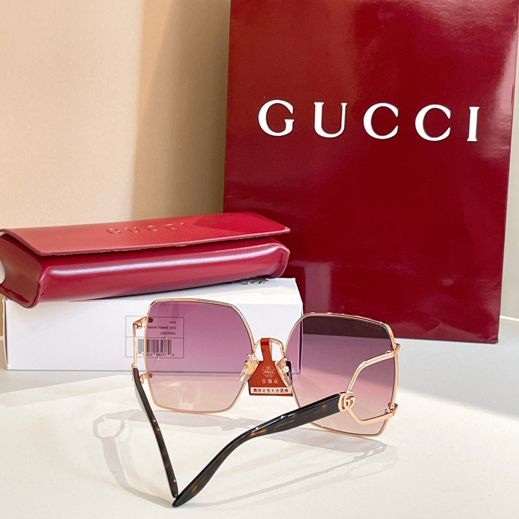 Oversized sunglasses with rose-gold frame and mauve tinted lenses, angled side view.