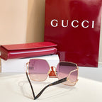 Oversized sunglasses with rose-gold frame and mauve tinted lenses, angled side view.