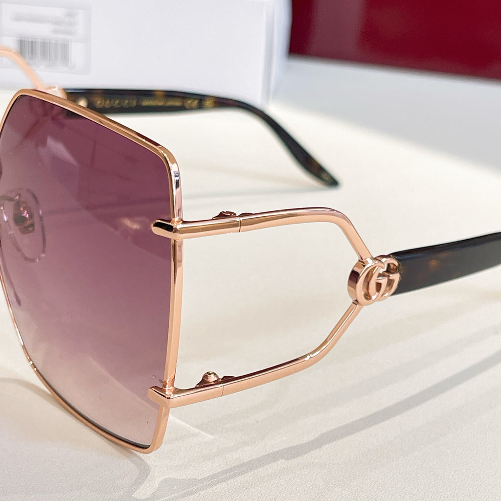 Rose-gold sunglasses with purple tinted lens and slim black temple, side view.