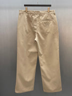 Louis Vuitton tan pants front view with belt loops and pleat detailing