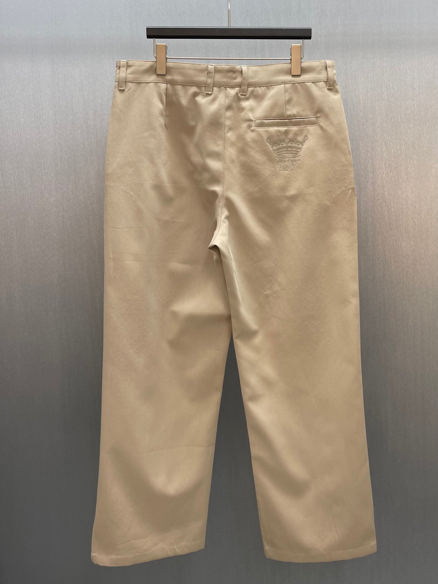 Louis Vuitton tan pants front view with belt loops and pleat detailing
