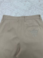 Louis Vuitton pants back view with crown emblem on pocket, light beige