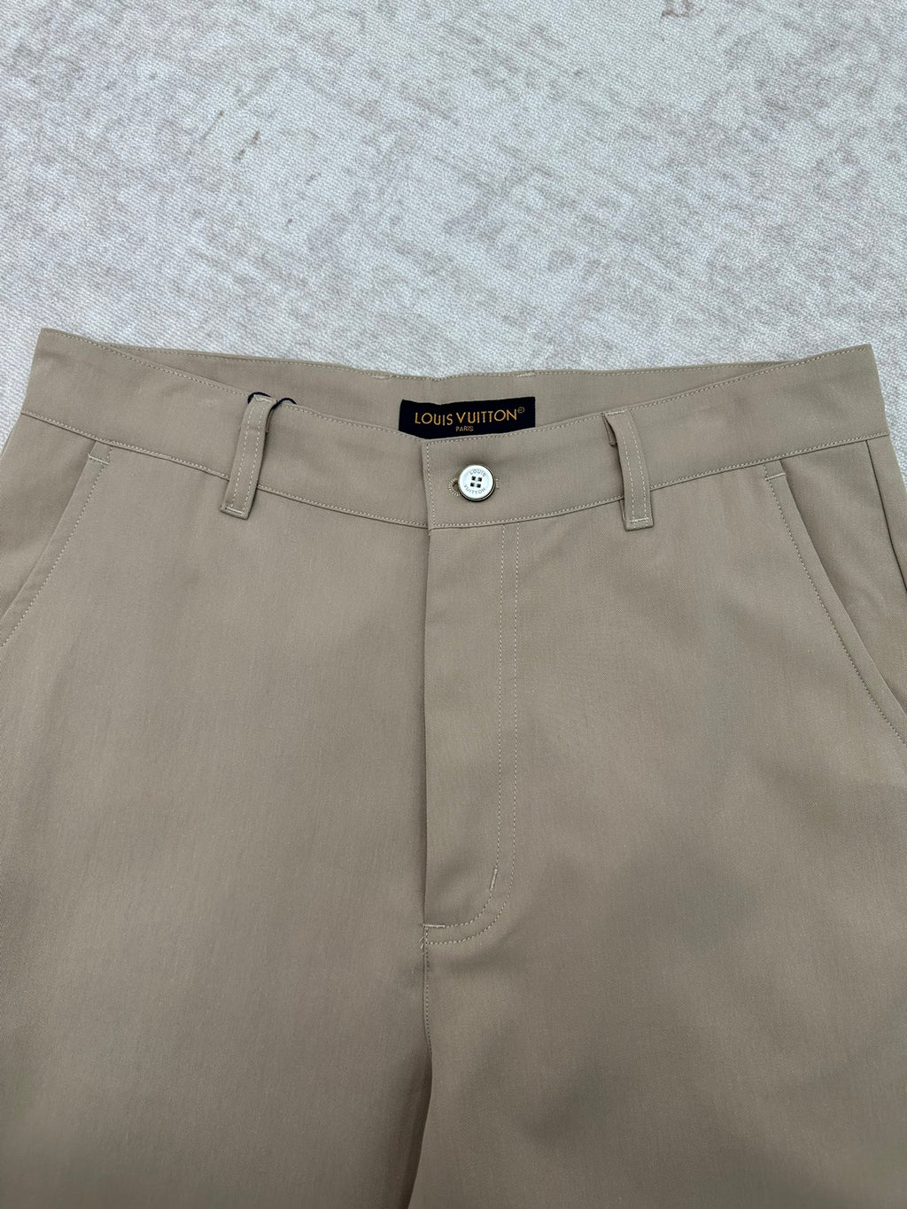 Louis Vuitton pants waistband detail with button closure and belt loops, light beige