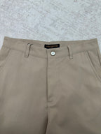 Louis Vuitton pants waistband detail with button closure and belt loops, light beige