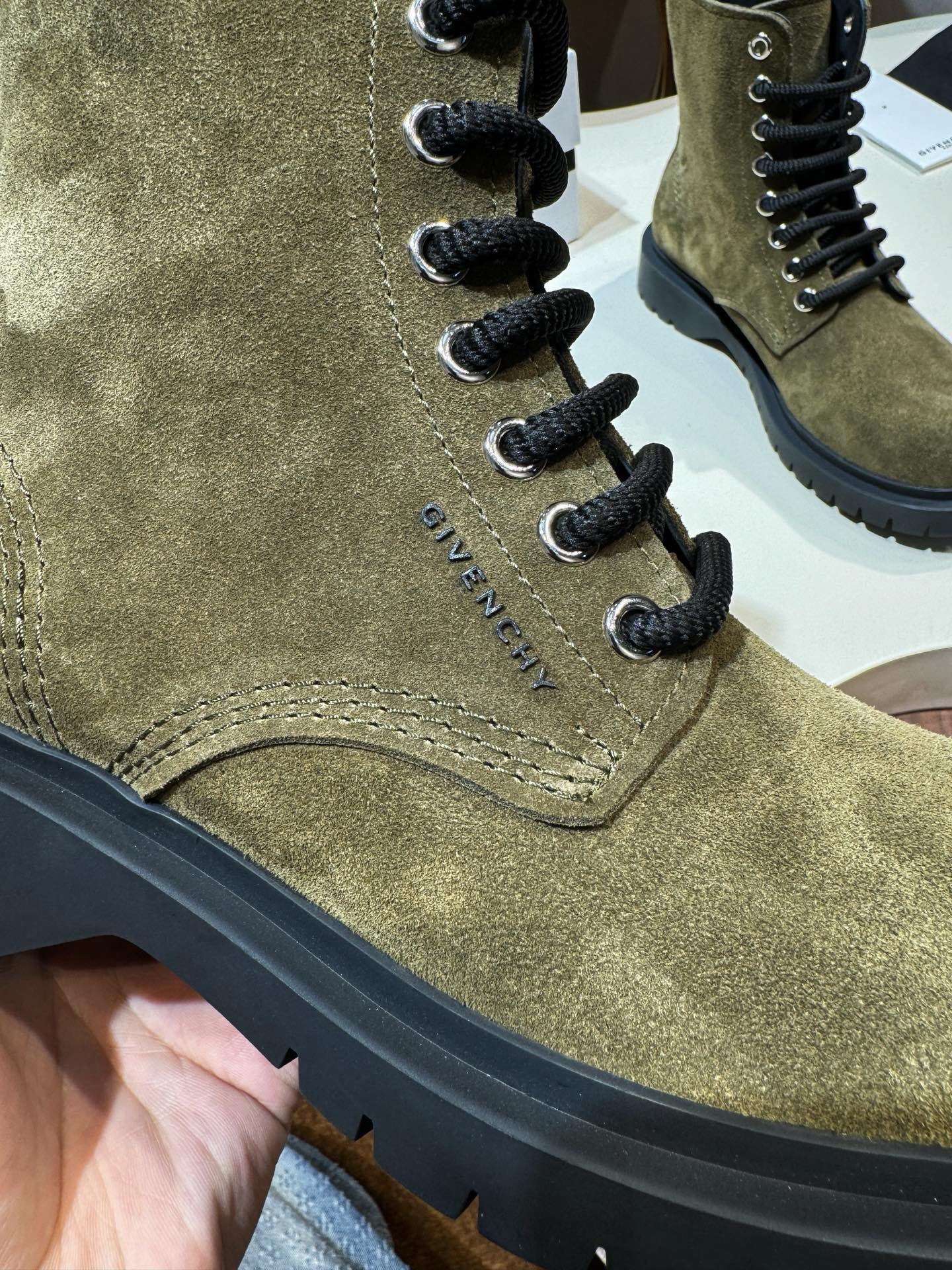 Givenchy olive suede ankle boot vamp with lace-up loops and stitched seams