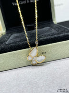 Gold butterfly pendant necklace with pale blue enamel petals and a fine chain