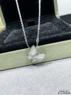 Silver butterfly pendant necklace with pale blue enamel petals on a chain