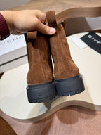 Givenchy brown suede boots viewed from back with black rugged soles