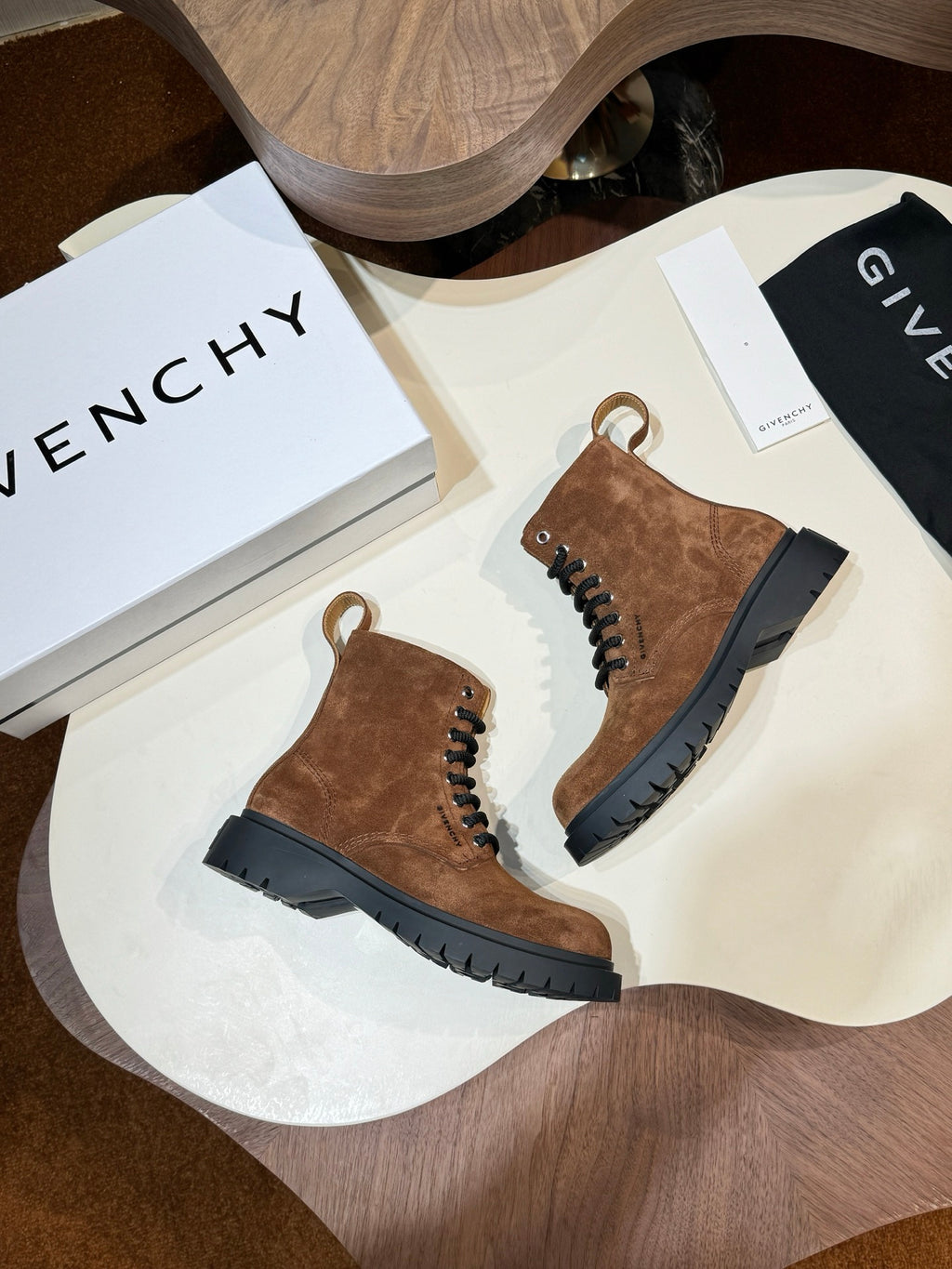Givenchy brown suede lace-up ankle boots on round display table