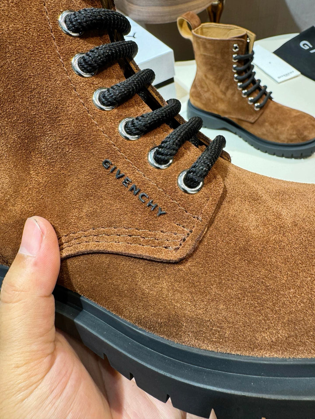 Givenchy brown suede lace-up boot close-up with black laces and side stitching