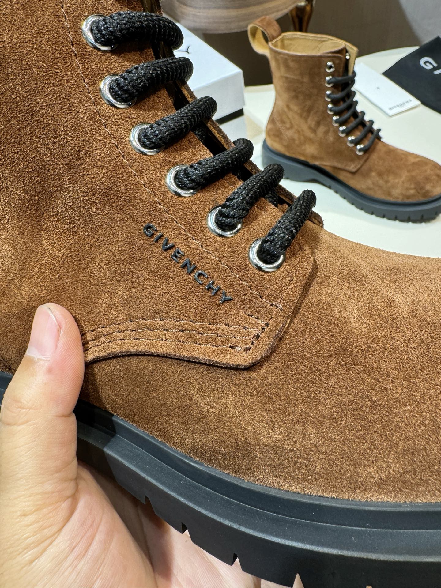 Givenchy brown suede lace-up boot close-up with black laces and side stitching