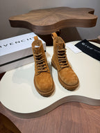 Pair of tan suede lace-up boots with rubber lug soles