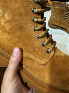 Tan suede lace-up boot close-up with GIVENCHY stitched text