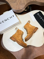 Tan suede lace-up boots on display with lug soles
