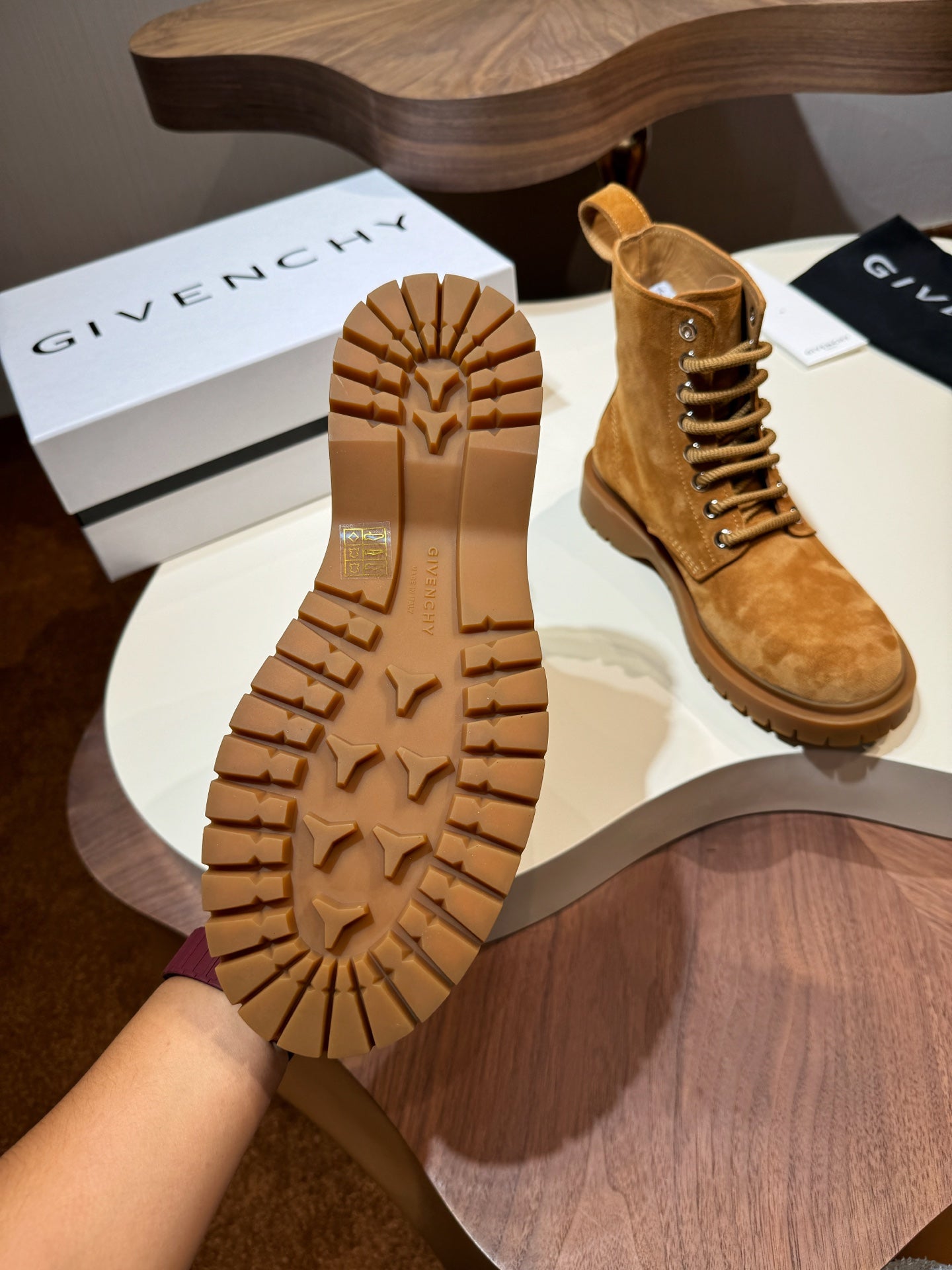 Tan suede lace-up boots with rugged lug tread soles