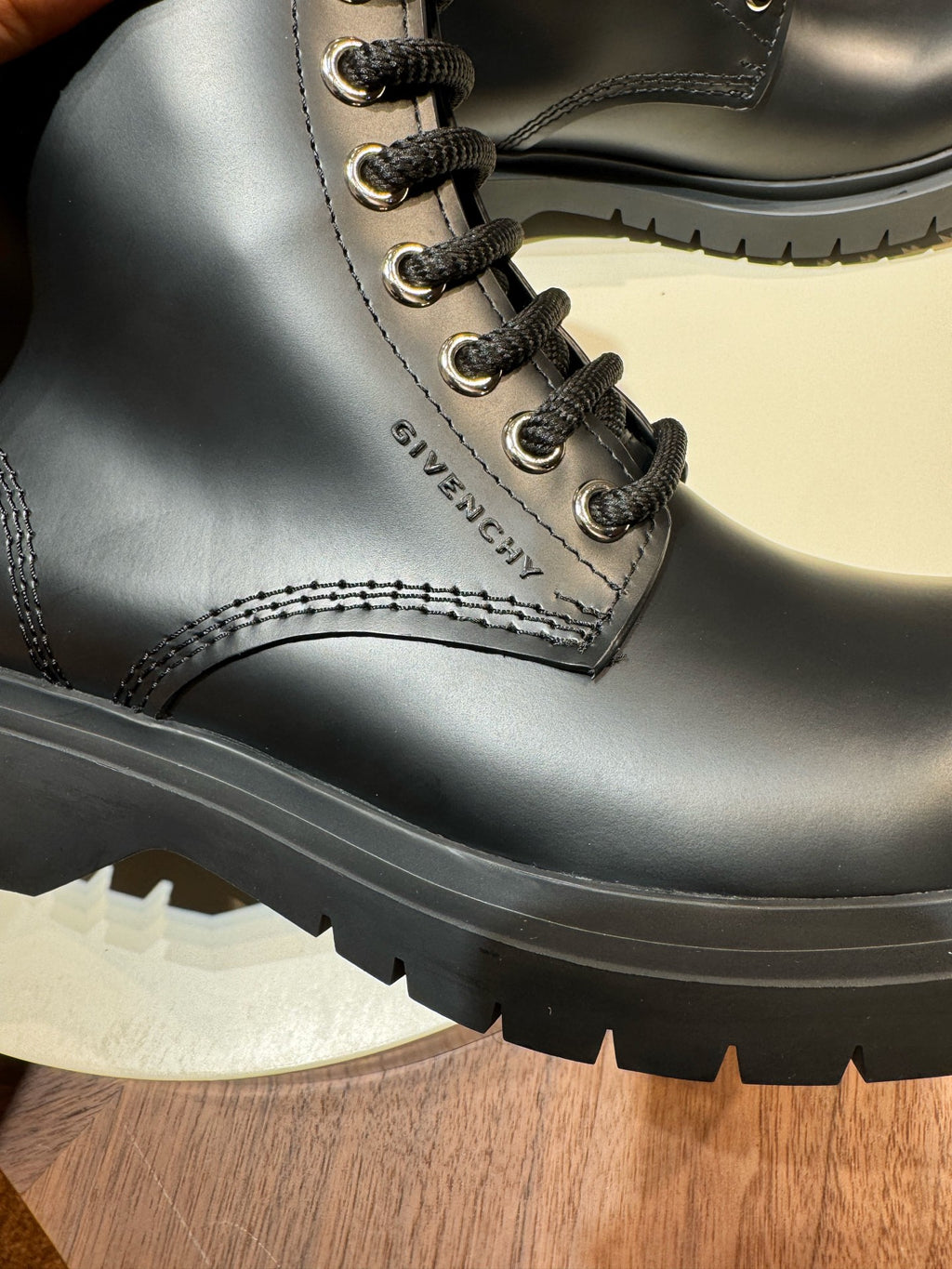 Givenchy black leather boot close-up, lace eyelets and tread sole