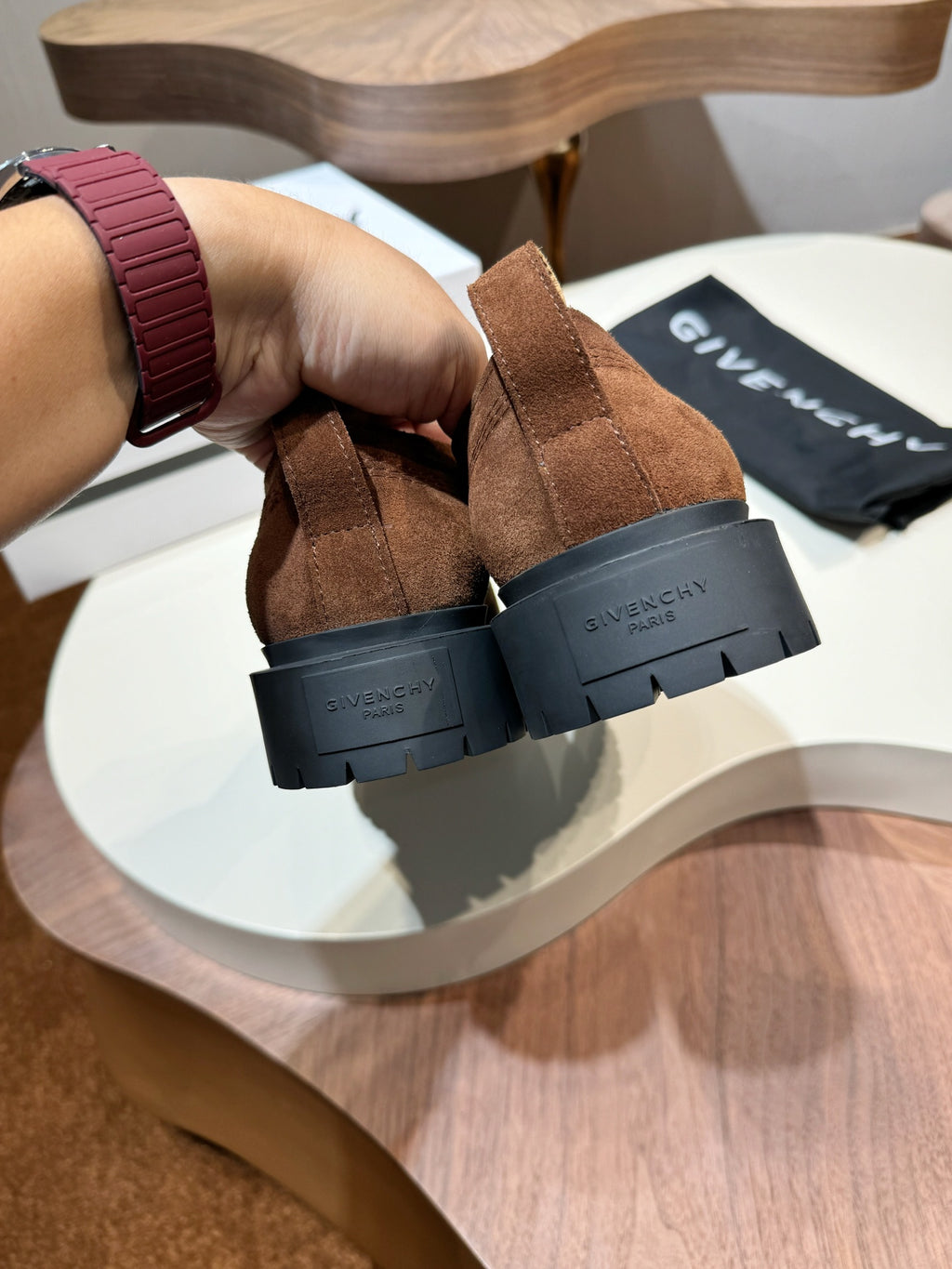 Brown suede lace-up shoes showing heel logo detail and black rubber sole
