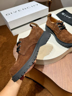 Brown suede lace-up shoe with black lug sole and lace-up front