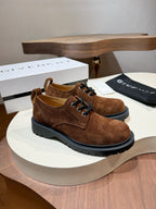 Brown suede lace-up shoes with black chunky soles and lace-up front